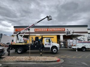 Trucks at lumber entrance, cloudy sky